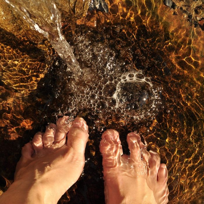 Person practicing traditional dew-treading after learning the history of hydrotherapy for natural health.